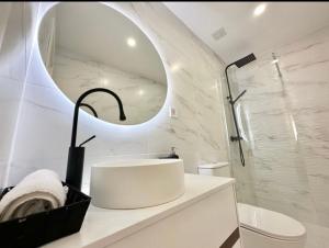 a white bathroom with a sink and a mirror at AdriVA Apartamento-Loft Imperial centro WIFI in Valladolid