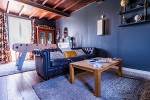 a living room with a couch and a table at No2 By The Fields in Canchy