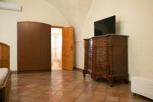 uma sala de estar com uma cómoda com televisão em B&B Vittoria em Gallipoli