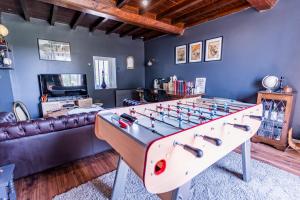 a living room with a large foosball table at No2 By The Fields in Canchy