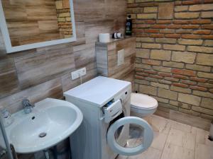 La salle de bains est pourvue d'un lavabo et de toilettes. dans l'établissement Kisfaludy Károly Apartman, à Győr