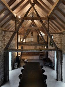 a large room with a large table in a building at Hoeve Appartement aan de rand van Maastricht met natuurzwembad in Berg en Terblijt