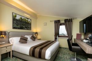 a hotel room with a bed and a desk at Castrum Wine Relais in San Pietro in Cariano