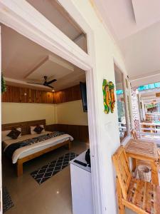 a bedroom with a bed and a balcony at The Stream Kasol in Kasol