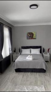 a bedroom with a large bed with white sheets at 9 Otel Samsun in Kalkanlı