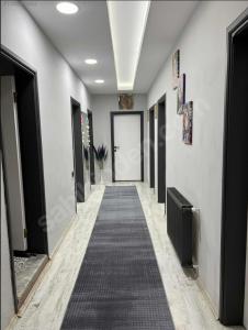 a hallway with a long carpet on the floor at 9 Otel Samsun in Kalkanlı