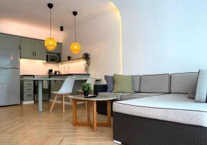 a living room with a couch and a kitchen at Bahia Residence Cabarete in Cabarete