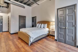 a bedroom with a large bed and a wooden floor at 1 Bedroom @ Grand Strand Brewery 202 in Myrtle Beach
