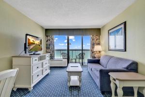 - un salon avec un canapé et une télévision dans l'établissement Compass Cove Resort 1052, à Myrtle Beach