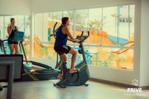 a man riding an exercise bike in a gym at Riviera Park Caldas Novas in Caldas Novas