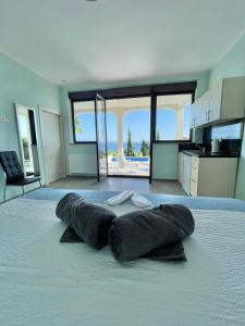 a room with some towels on a bed with a kitchen at Villa Nikolla in Lovran +30 photos
