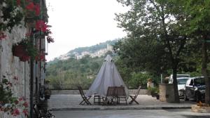 a table and chairs and a tent in a courtyard at BB Casavacanze Corneto in Bomba