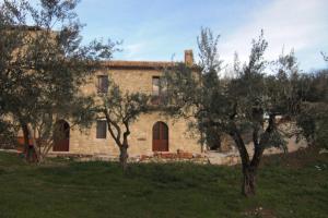 an old stone house with trees in front of it at BB Casavacanze Corneto in Bomba