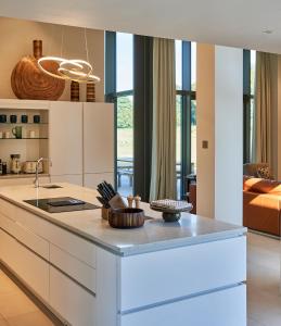 a kitchen with a white island in a room at Avington Estate in Winchester