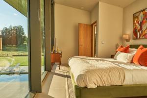 a bedroom with a bed and a sliding glass door at Avington Estate in Winchester