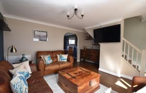 a living room with a couch and a coffee table at Snaffles a family friendly holiday cottage in Rye Harbour