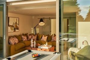 a living room with a couch and a table at Avington Estate in Winchester