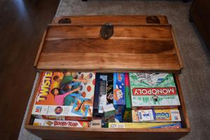 a wooden chest filled with magazines and books at Snaffles a family friendly holiday cottage in Rye Harbour