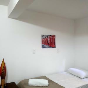 a bedroom with two beds and a picture on the wall at Casa Sol do Gostoso in São Miguel do Gostoso