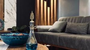 a glass bottle on a table next to a couch at Meridiani Taksim Hotel in Istanbul