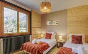 a bedroom with two beds and a window at Chalet Sol in Chamonix