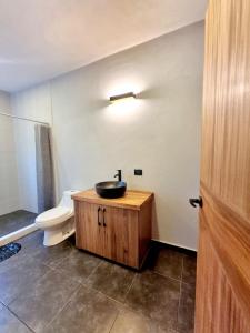 a bathroom with a sink and a toilet at Casa Tankah in Tulum