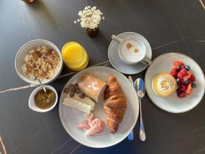- une table avec des assiettes de produits pour le petit-déjeuner et une tasse de café dans l'établissement Ma Bauge, à Libin