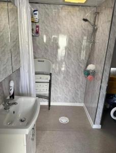 a bathroom with a shower and a sink at Disabled 4 Berth in Ingoldmells Maples Lodge in Ingoldmells