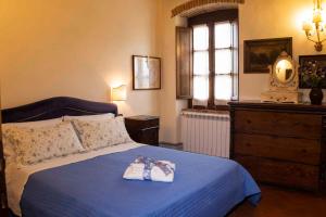 a bedroom with a bed with two towels on it at Apartment in Capolona Arezzo - Toskana 41977 in Campoluci +2 photos