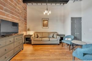 a living room with a couch and a tv at Hoppy Hideaway: Coastal Loft with a Brewery Twist in Myrtle Beach