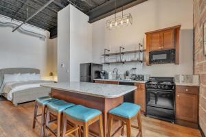 a kitchen with a large island in a room with a bed at Hoppy Hideaway: Coastal Loft with a Brewery Twist in Myrtle Beach