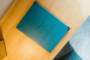 a blue paper on a table with the word faith at The Dunes in Tenby
