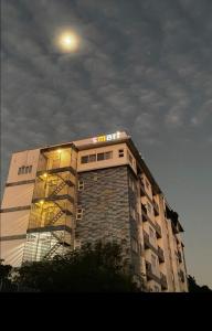 a building with a sign on the top of it at Smart Condominium Official in Cagayan de Oro