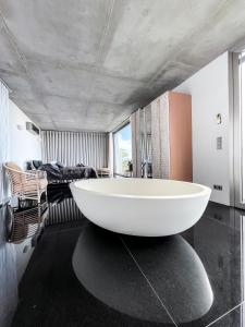 a bathroom with a large white tub in a room at Casa el Goce - Luxury Villa, private pool, BBQ and bathtub in Tijarafe