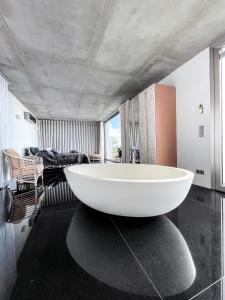 a bathroom with a large white tub in a room at Casa el Goce - Luxury Villa, private pool, BBQ and bathtub in Tijarafe +26 photos