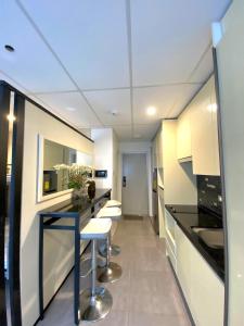 a kitchen with black counter tops and white cabinets at Smart Condominium Official in Cagayan de Oro