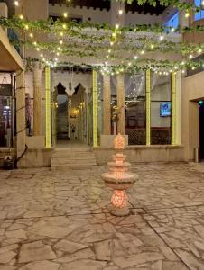 a fountain in the middle of a building with lights at Hyba Pod Hostel & Hotel in Dubai