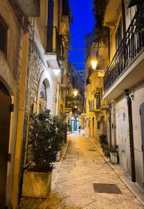 an empty street at night in a city at Una finestra sul mare in Bari +46 photos