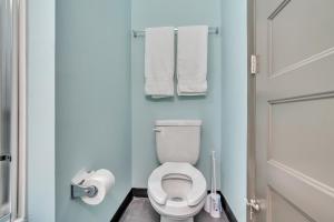 a small bathroom with a toilet and towels at 1 Bedroom @ Grand Strand Brewery 210 in Myrtle Beach