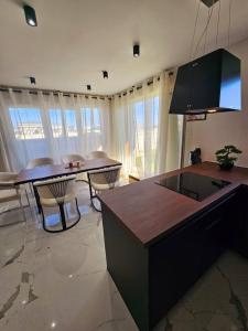 a kitchen with a table and chairs in a room at Stylish rooftop avec terrasse à 2pas de Disney Paris in Montévrain