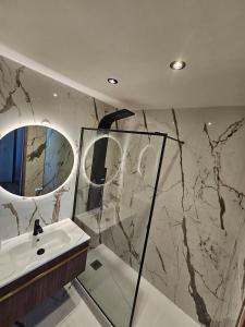 a bathroom with a sink and a mirror at Stylish rooftop avec terrasse à 2pas de Disney Paris in Montévrain +32 photos