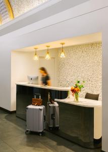 a lobby with two suitcases in front of a counter at Sonder City Hall Park in New York