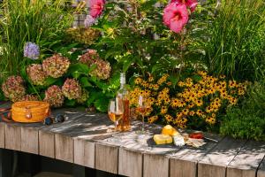 a table with a glass of wine and some flowers at Sonder City Hall Park in New York