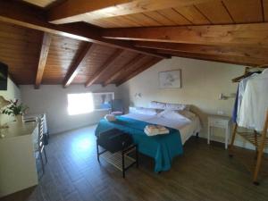 a bedroom with a bed and a table in a room at B&B dal Cardinale in Ozieri