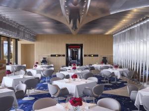 a banquet hall with white tables and chairs at The Peninsula London in London