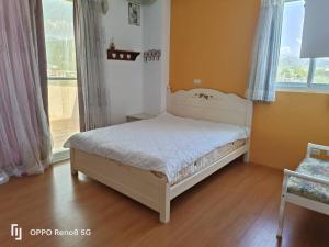 a small bedroom with a bed and a window at 茶樂二重奏 in Taitung City