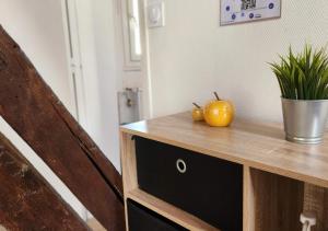 a wooden dresser with two apples on top of it at L'Etape Tourangelle in Tours +19 photos