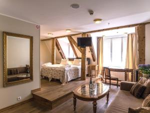 a living room with a bed and a mirror at CRU Hotel in Tallinn
