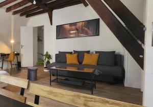 a living room with a couch and a table at L'Etape Tourangelle in Tours