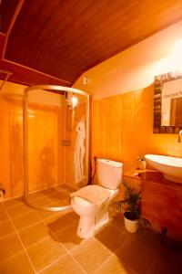 a bathroom with a toilet and a shower and a sink at Havana Nights Phi Phi in Phi Phi Islands